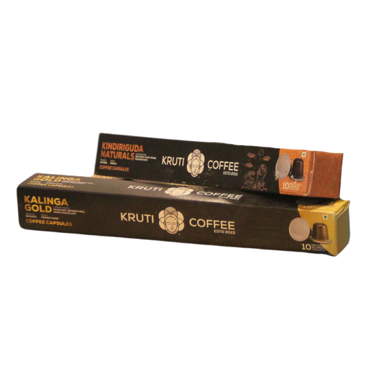Boxes of Kruti Coffee and Kalinga Gold coffee capsules on a gray background