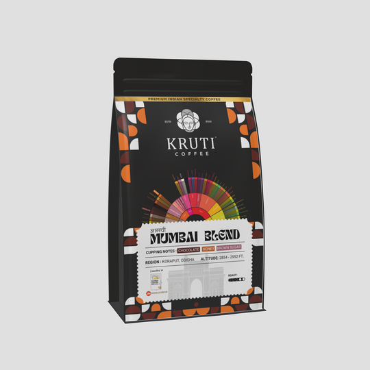 A packaged bag of Mumbai Blend coffee from Kruti Coffee with a colorfully segmented design and text detailing the product.