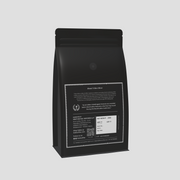 Tribes Silver Coffee Pack behind packaging displayed on a grey color background
